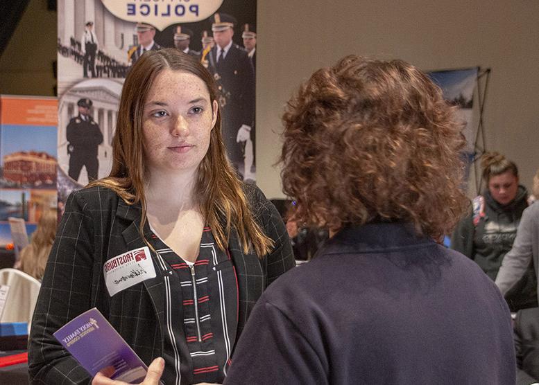 student at career fair speaking with potential employer